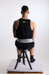 Whole Body Man White Sports Shorts Slim Athletic Sitting Top Studio photo references